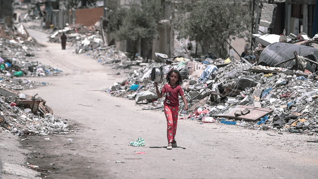 A girl walks inside Gaza during the Gaza Israel war to get food